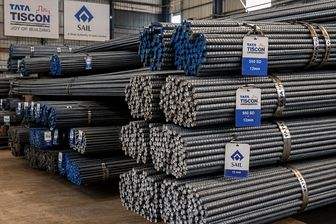 Bundles of TMT bars stacked and strapped, with Tata Tiscon and SAIL tags tied to the ends